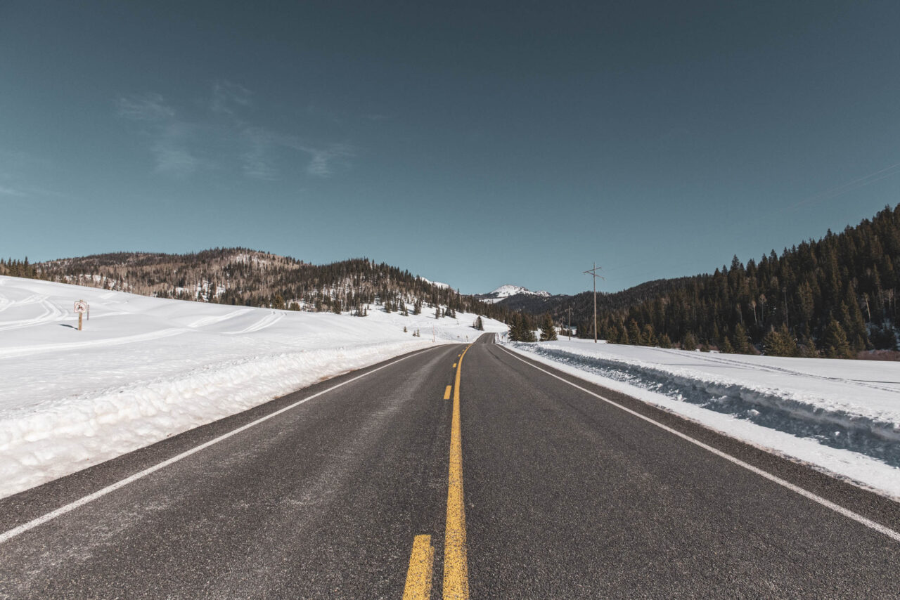 A Highway road with snow and mountains